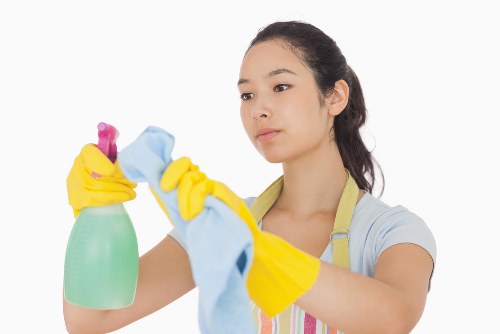 Cleaner preparing a tidy residential living room in NW1