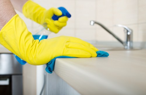 Cleaner maintaining desks and shared office surfaces in NW1